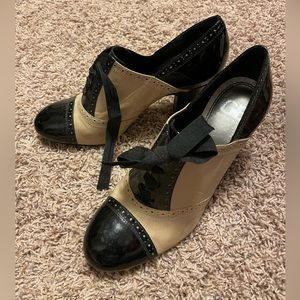 Next to new black and tan stack heel booties, cute detailing! 9